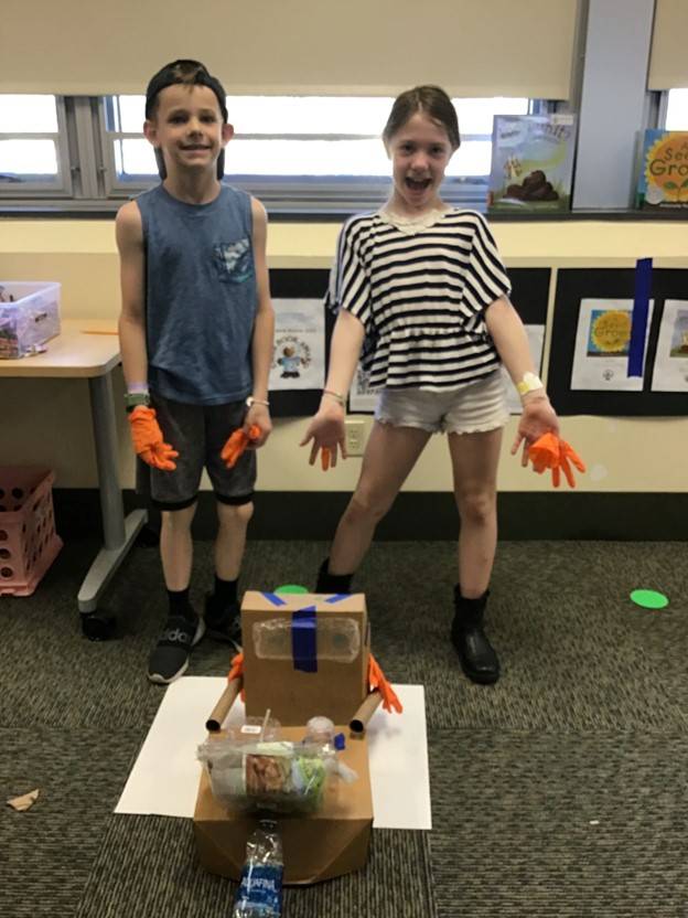 indoor learning, two students displaying their design thinking project